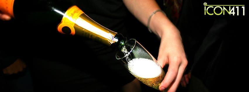 Champagne poured into a flute glass at a lively venue